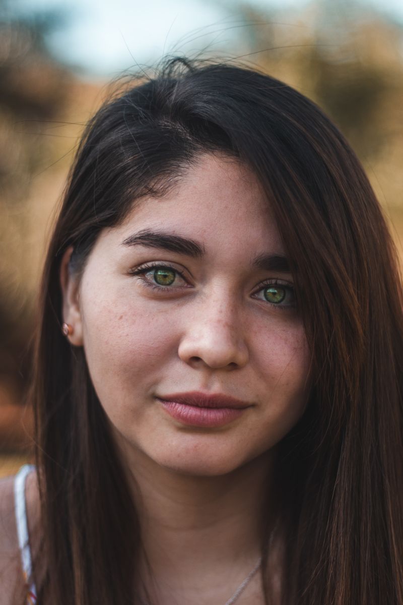 green eyed woman acne scar treatment long hair