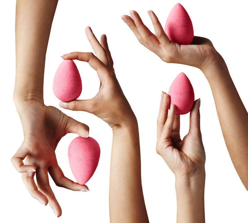 hands holding the original pink beauty blender