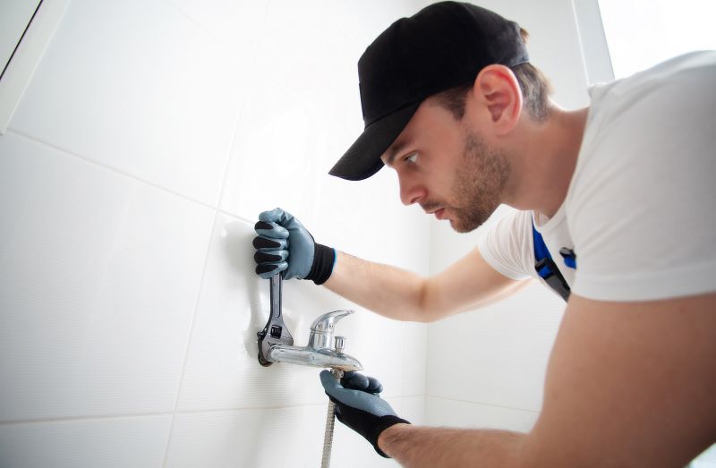 man changing shower head common bathroom issues