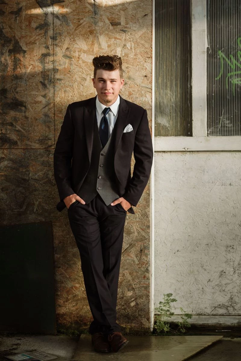 man dressed in black suit high school graduation outfit ideas