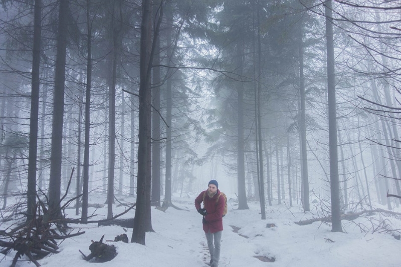 man in the forest thermal underwear snowing