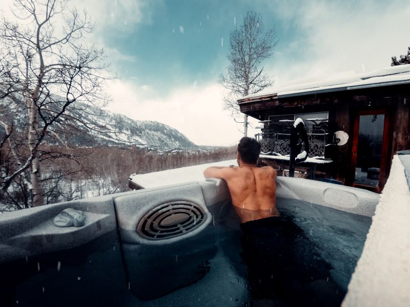 outdoor hot tub installation man inside