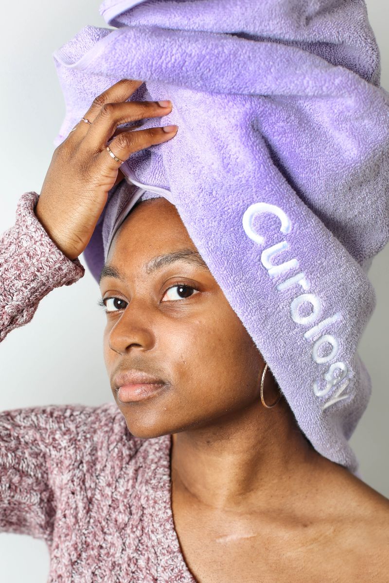 purple towel on womans head acne scar treatment