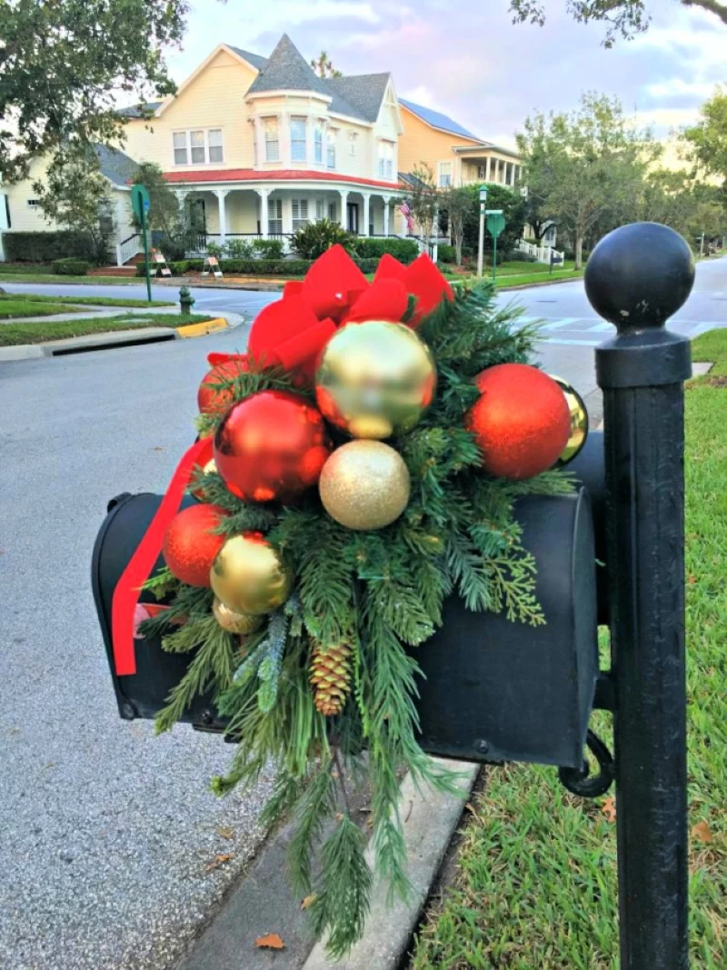 red and gold baubles on black christmas mailbox decor