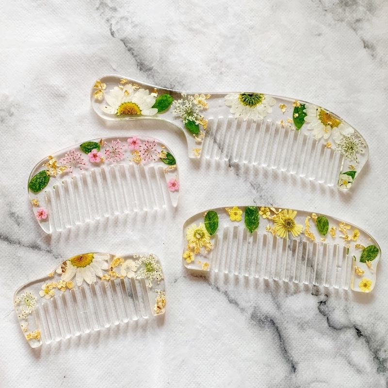 set of unique resin hair combs with embedded flowers