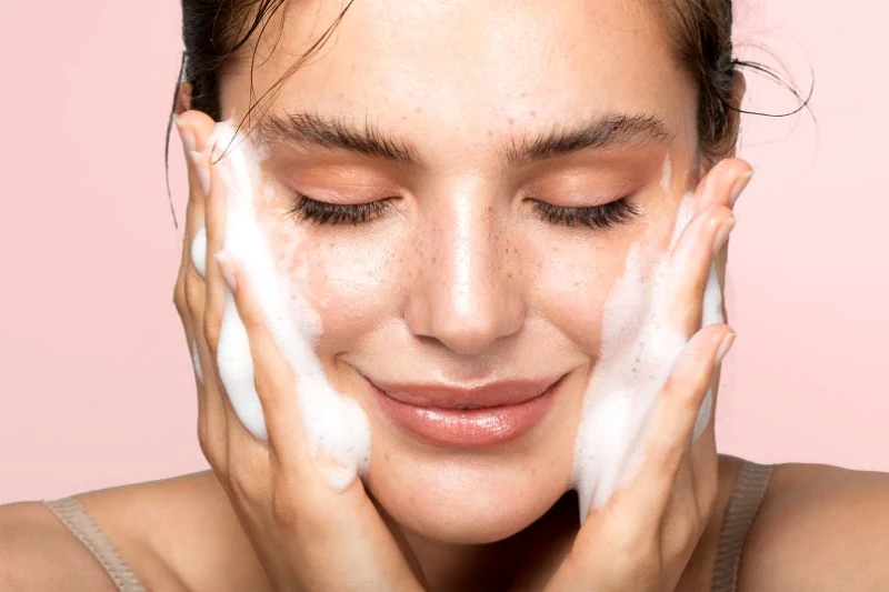 skin care regimen cleanser on face