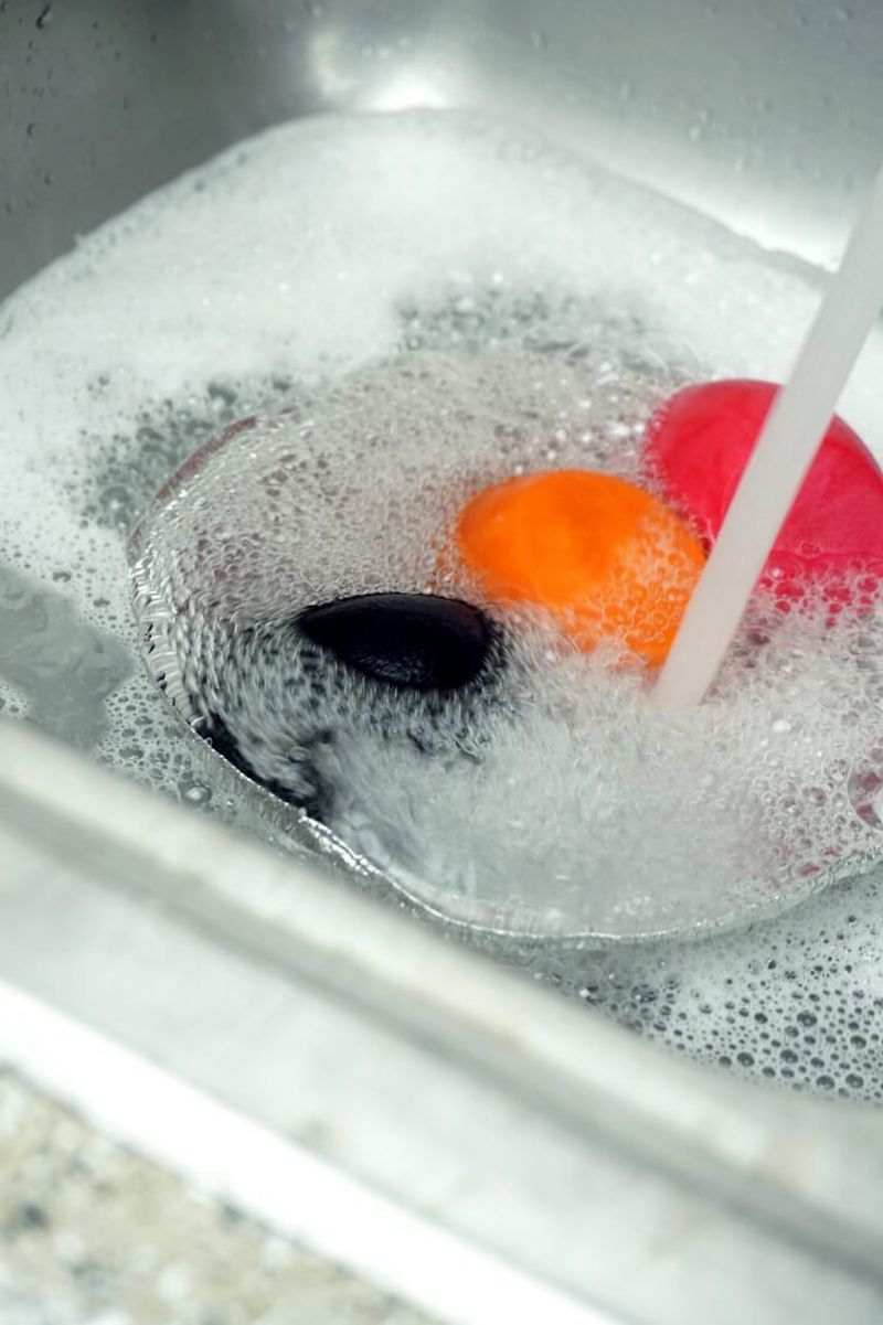 soaking colorful beauty sponges in water and soap