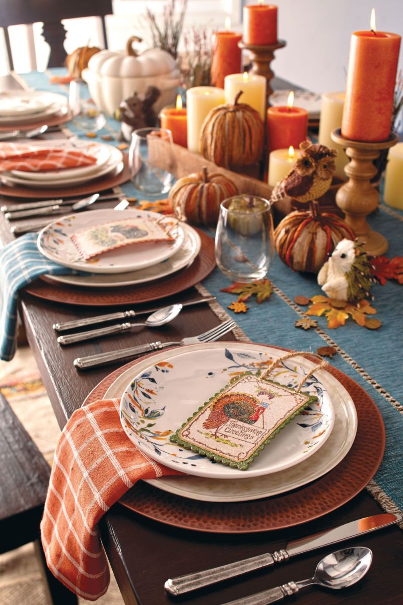 thanksgiving dinner table set with plates napkins