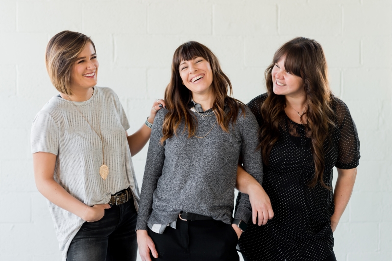 three women smiling mental health