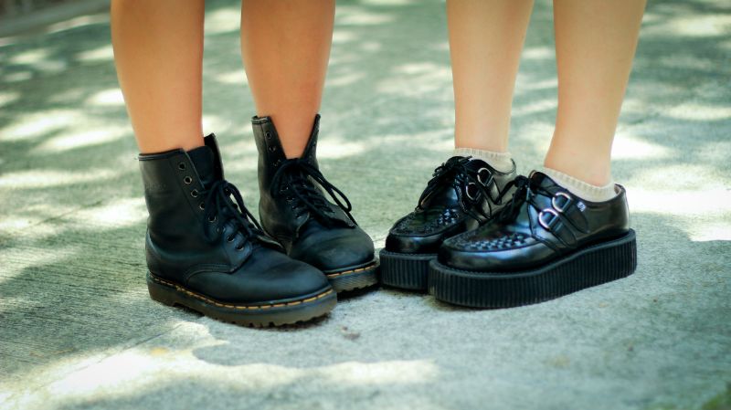 two people wearing platform boots women in black