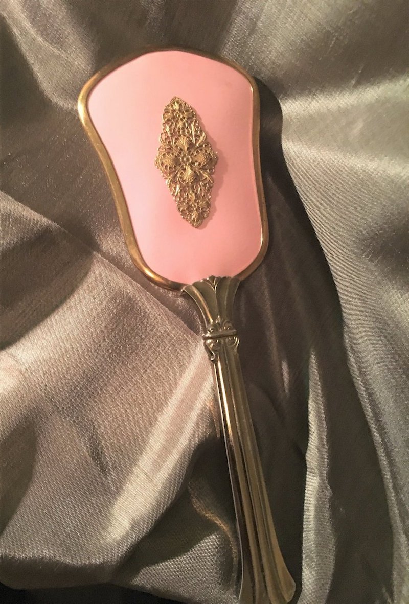 unique old model hair brush with gold metal and pink details