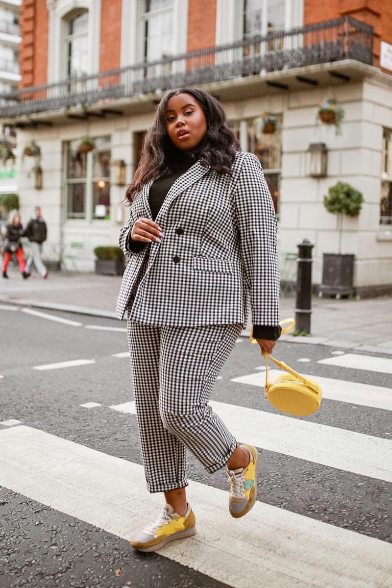 woman black white suit and yellow sneakers