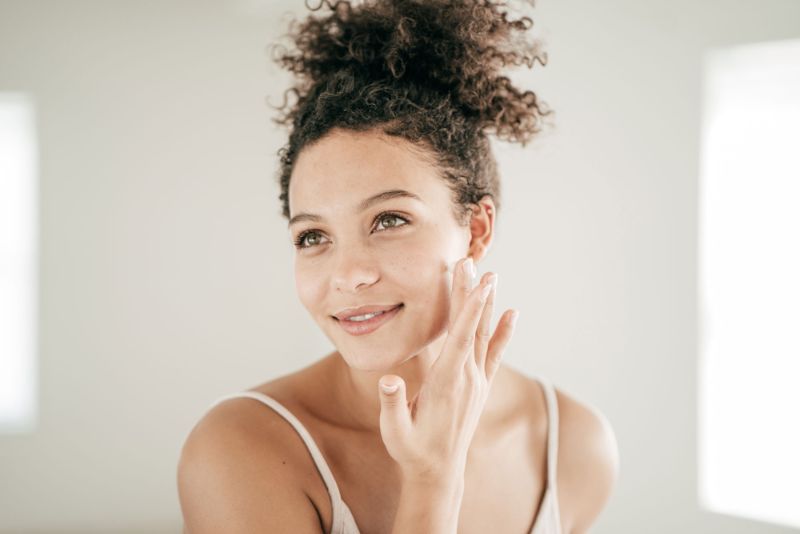 woman putting on cream best skin care routine