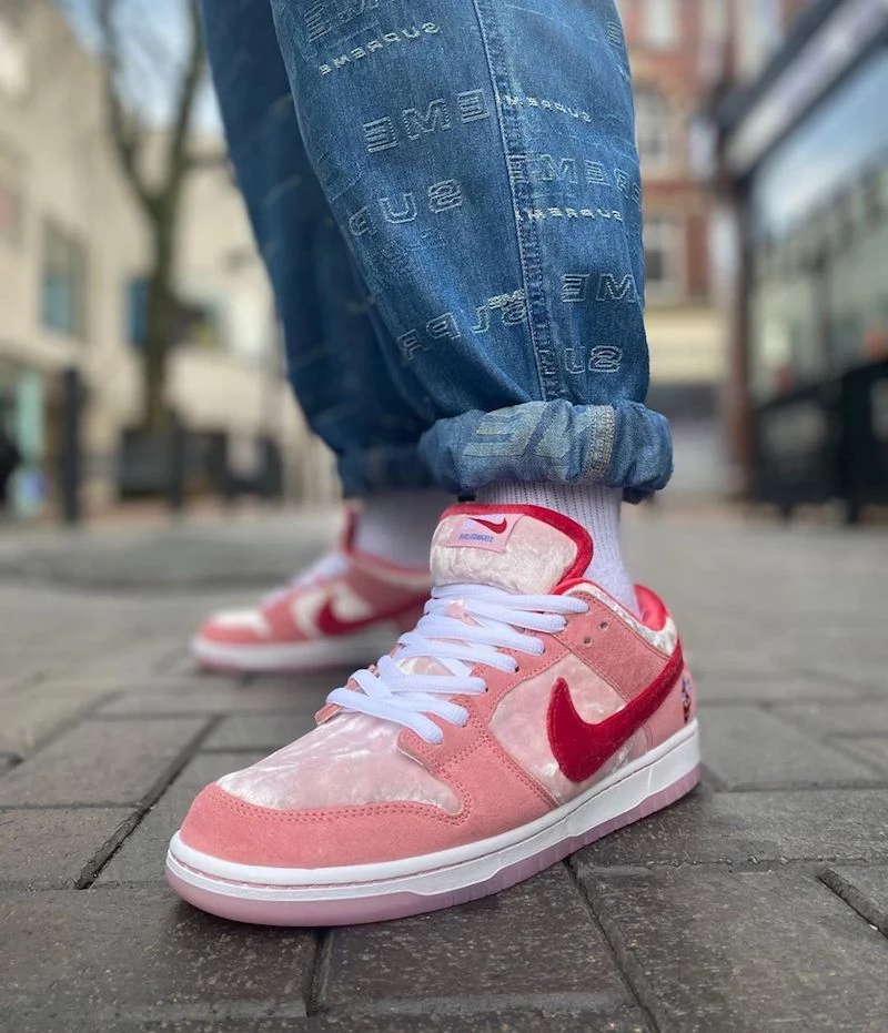 women model nike dunks suede sneakers in red and pink with velvet