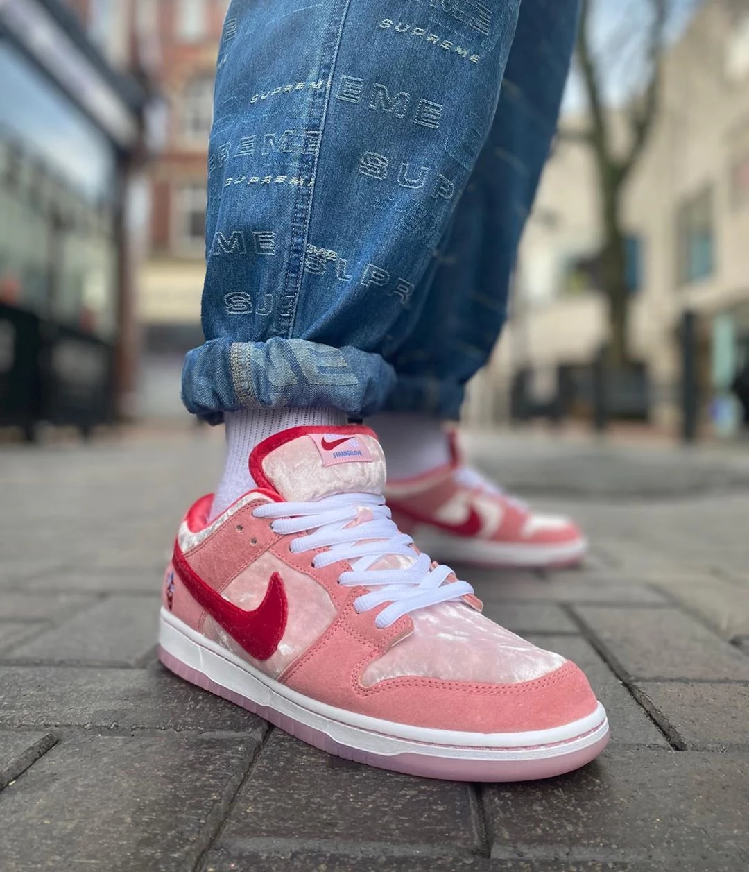 women model nike dunks suede sneakers in red and pink with velvet
