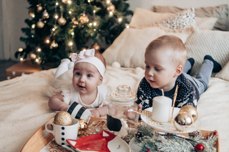 children celebrating christmas day at home with presents