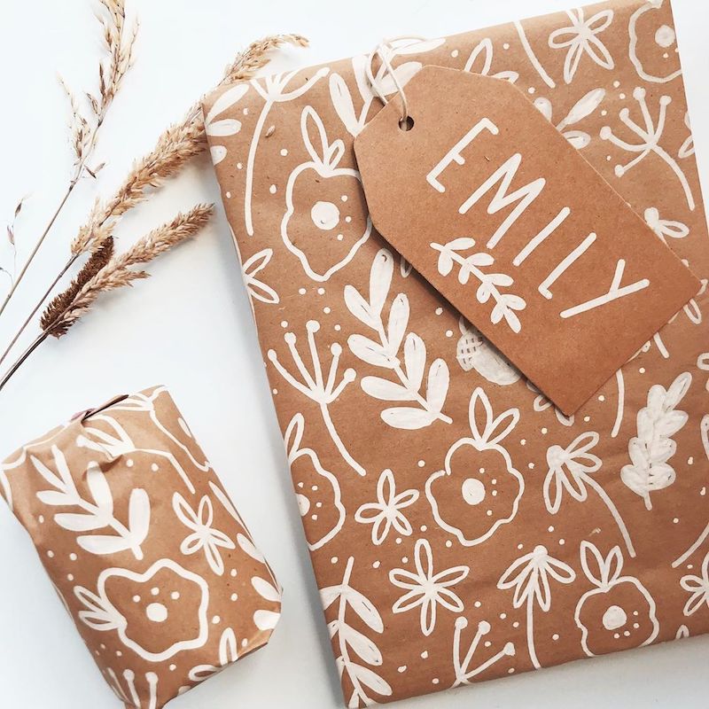 diy unique handrawn christmas wrapper design with white flowers and branches
