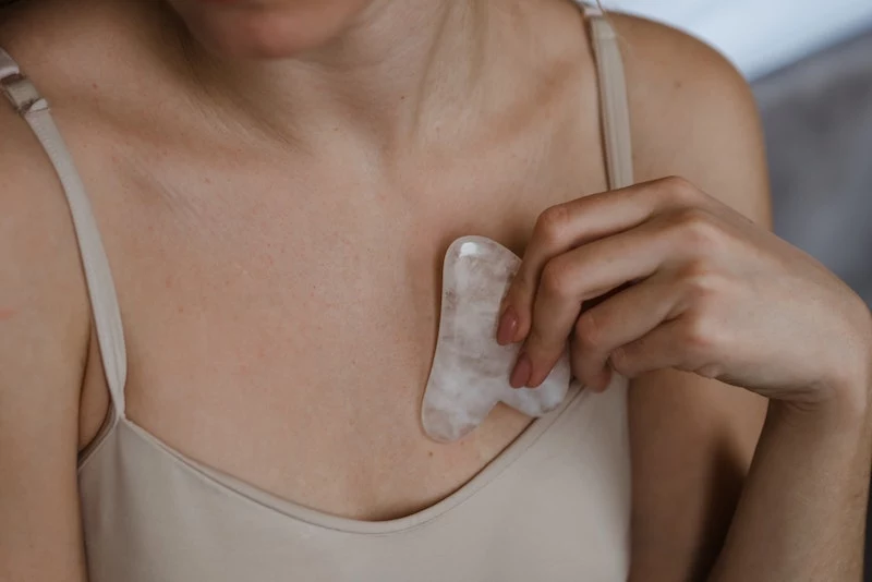 how to use a gua sha stone at home for neck area and chest