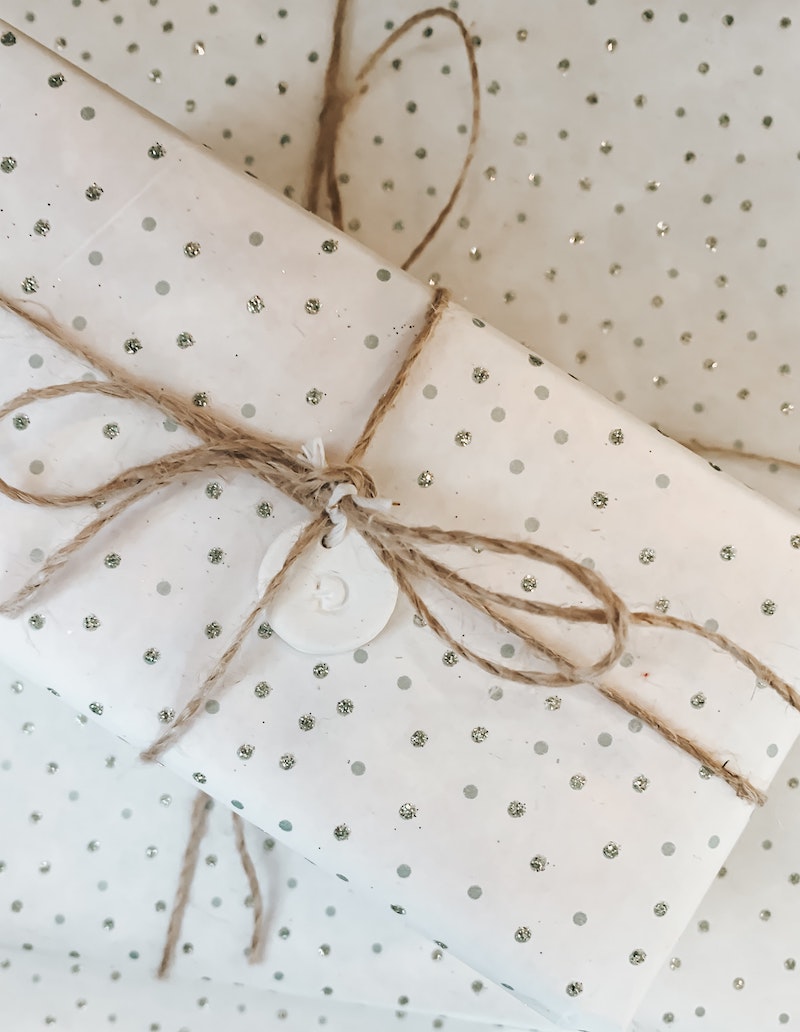 minimalistic christmas wrapper design with small silver polka dots and glitter
