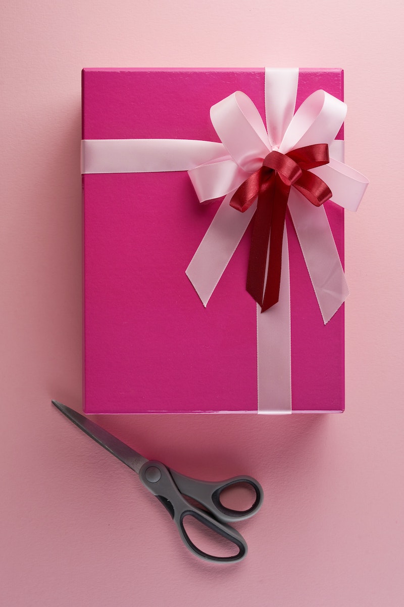 picture of a christmas present wrapped with pink paper and a double ribbon
