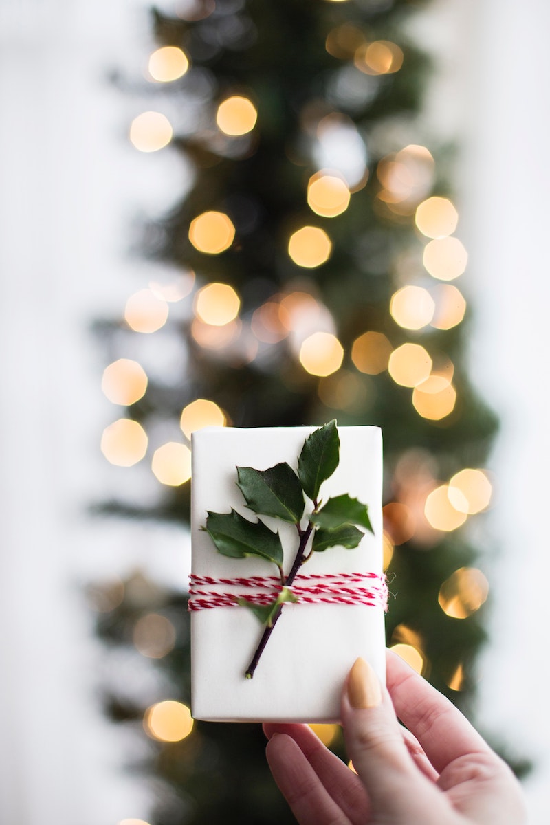 unique wrapped christmas presents under tree with natural elements