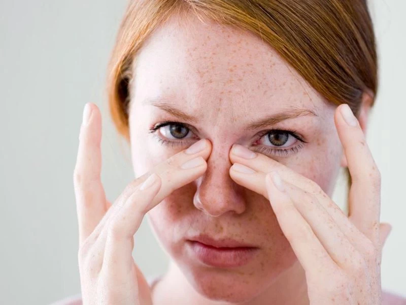 how to relieve sinus pressure redhead woman with nasal congestion