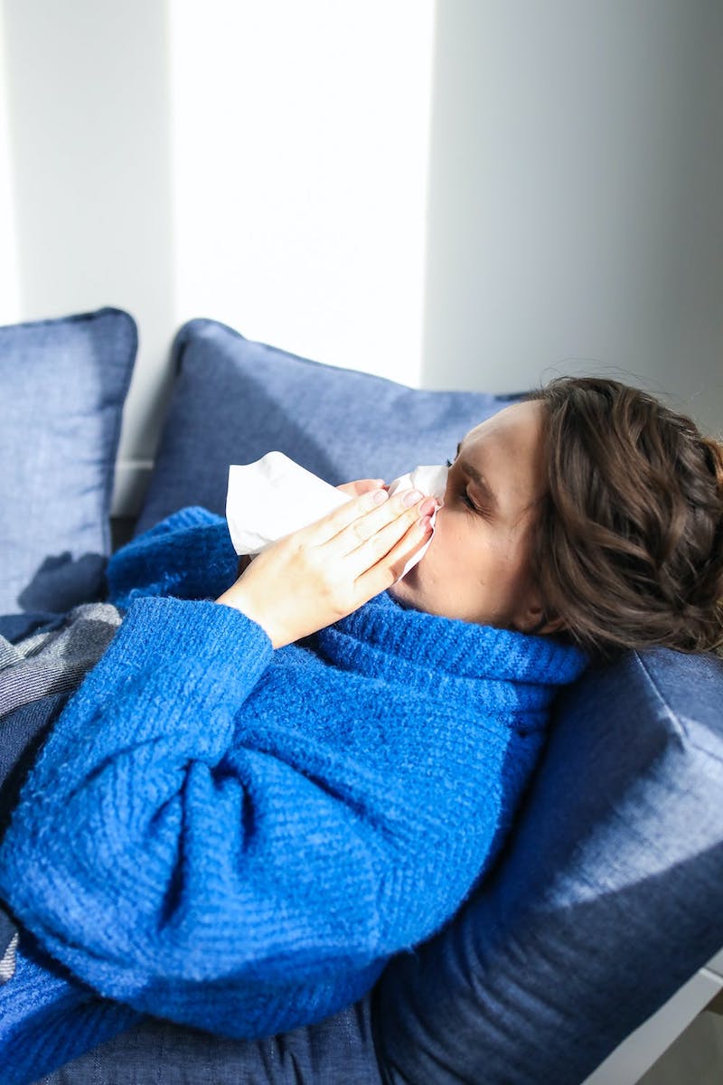 how to unclog your nose stuffy nose woman with blue sweater