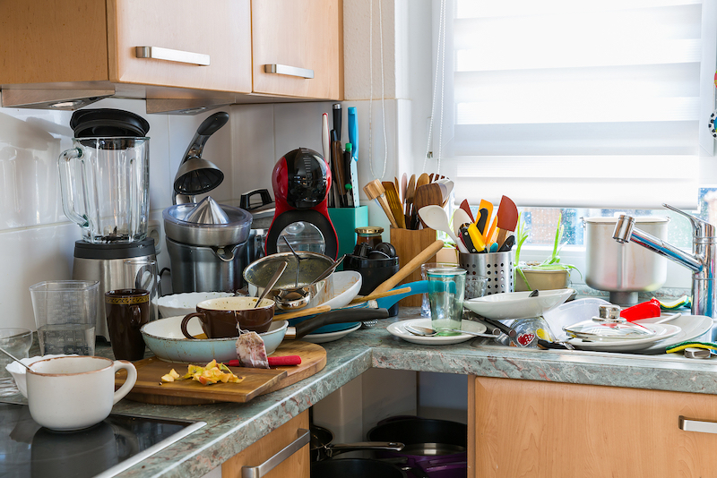 compulsive hoarding syndrom messy kitchen with pile of dirty dishes