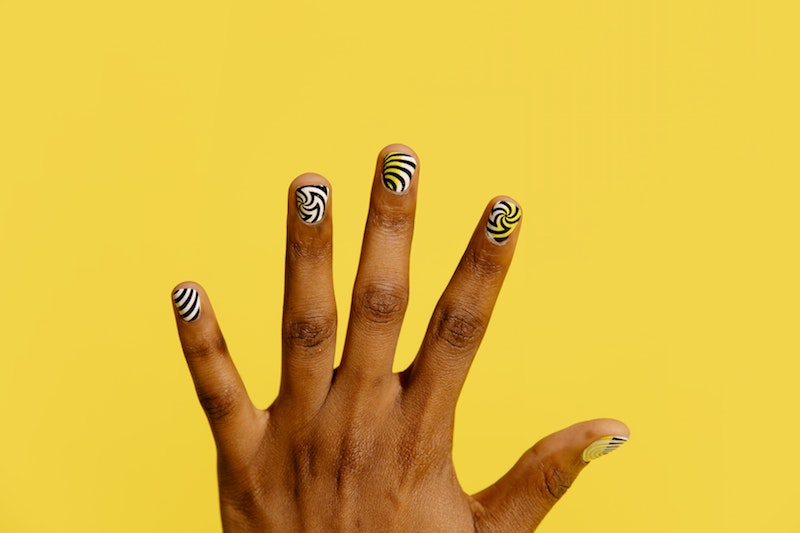 multi colored nails nails on yellow background