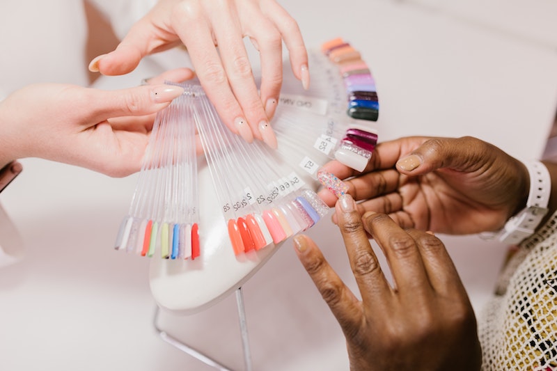 spring acrylic nails lady picking out nail designs