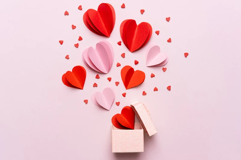 valentine day composition with gift box and red hearts, photo template on pink background.