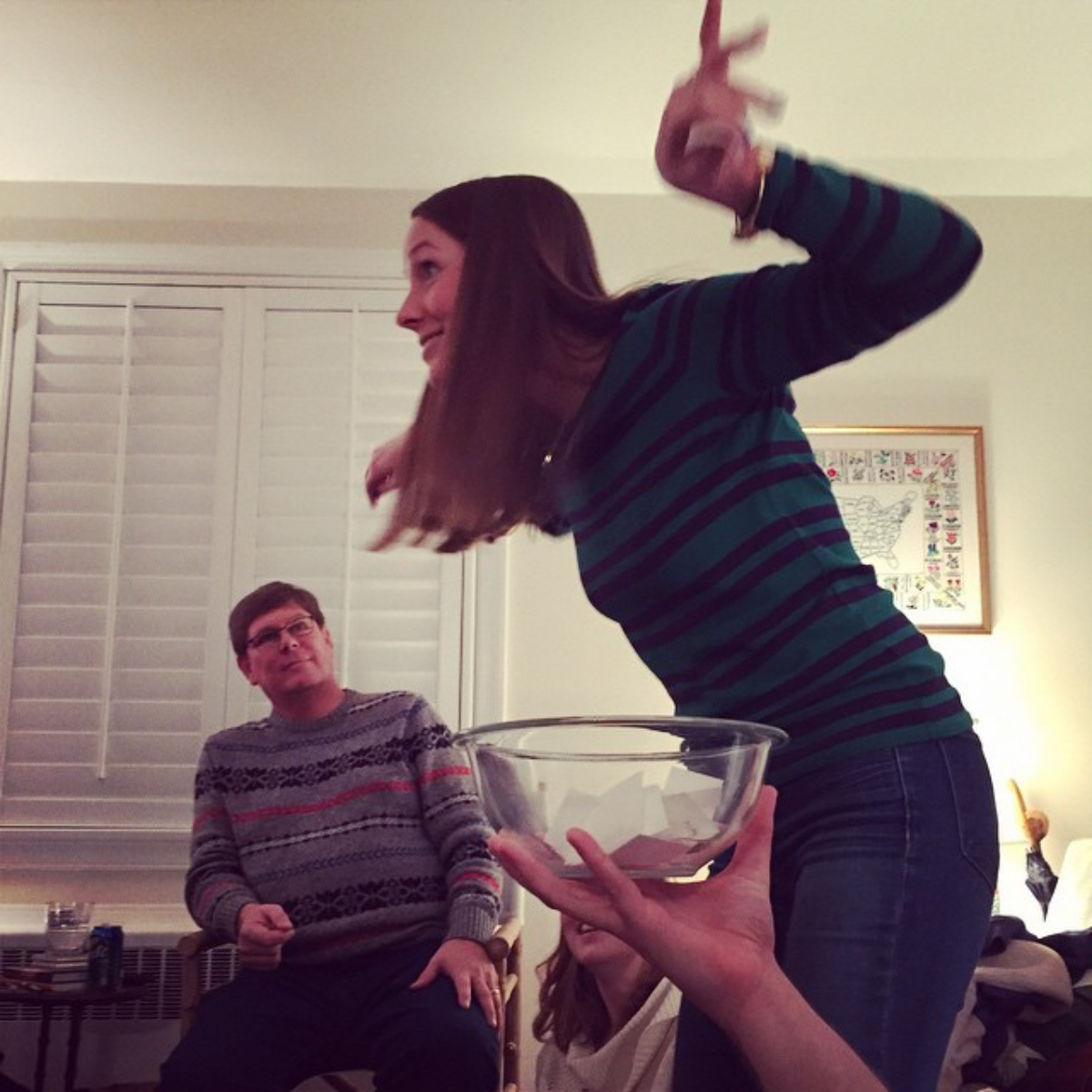 woman playing charades with family