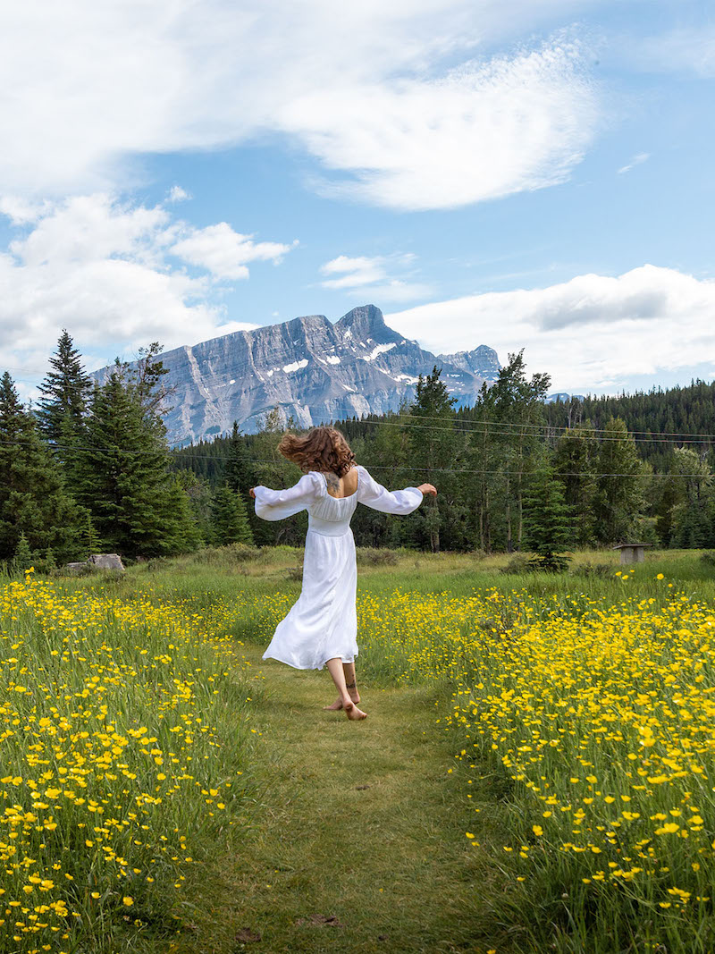 cottagecore background woman in white dress frolicking