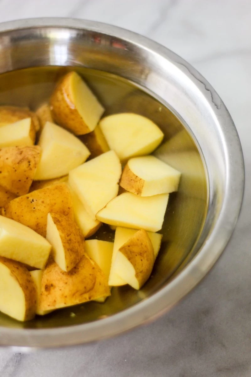 how to air fry potatoes soaking potatoes in a bowl
