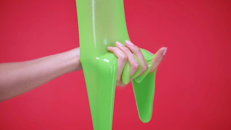neon squishy like slime too sticky hand with jelly green slime on red background