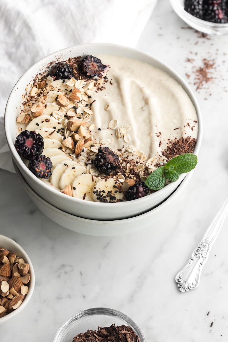 banana nut smoothie bowl with tahini honey and almonds