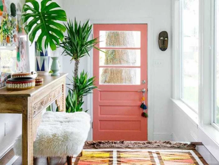 colourful entryway with coloured aztec rug pink door and moroccan side table