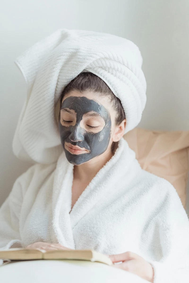 how to get rid of blackheads on nose woman reading book with mask