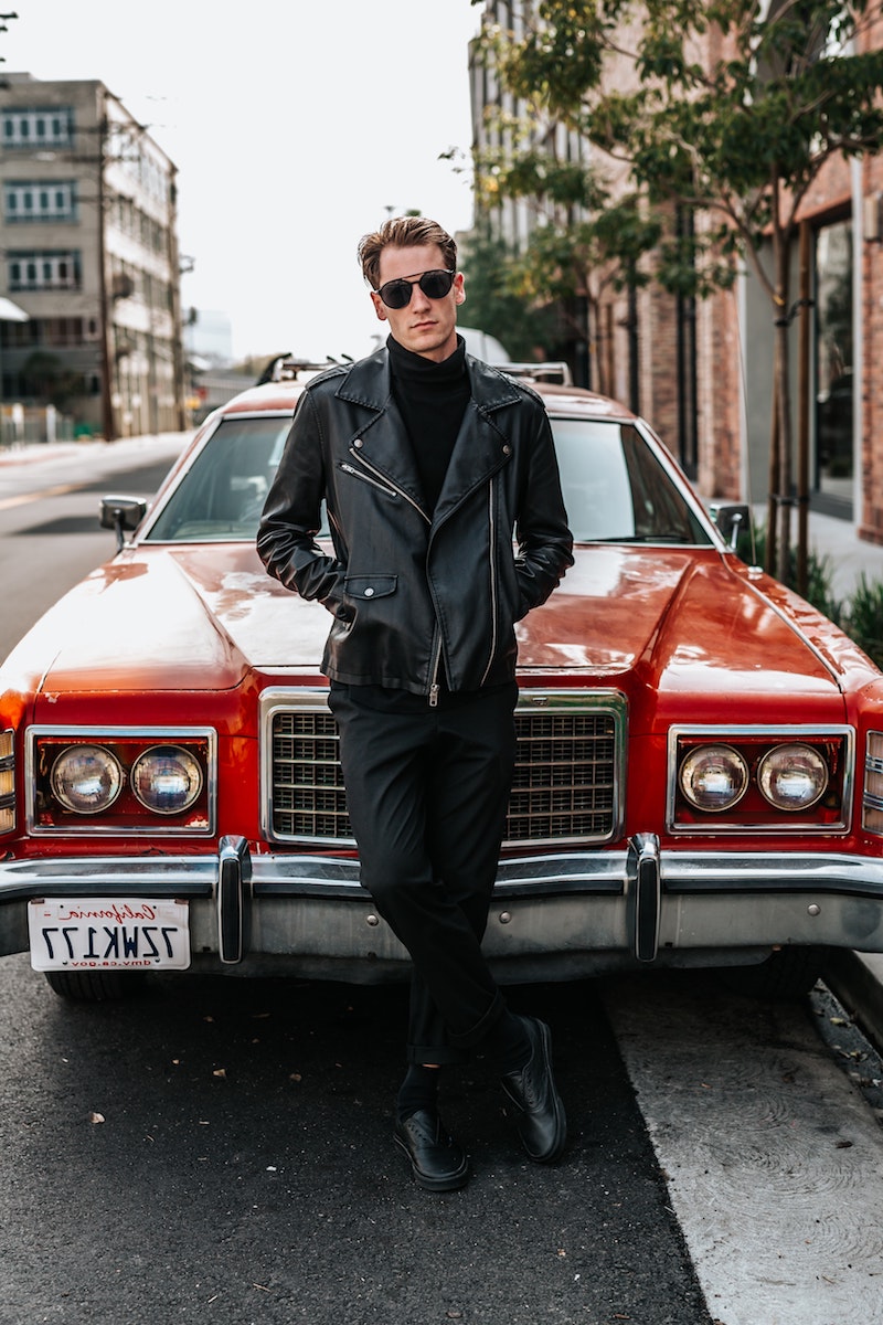 man in front of the car with leather jacket