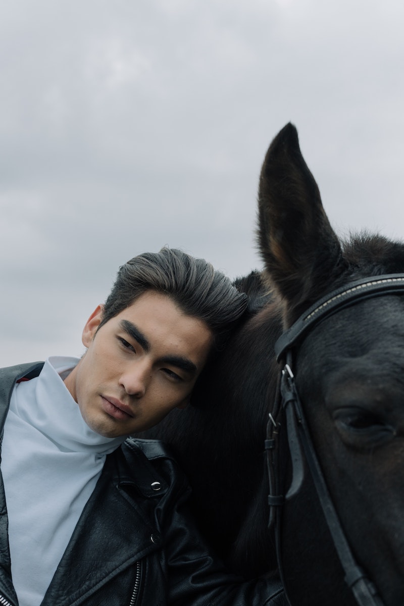 man with horse and leather jacket