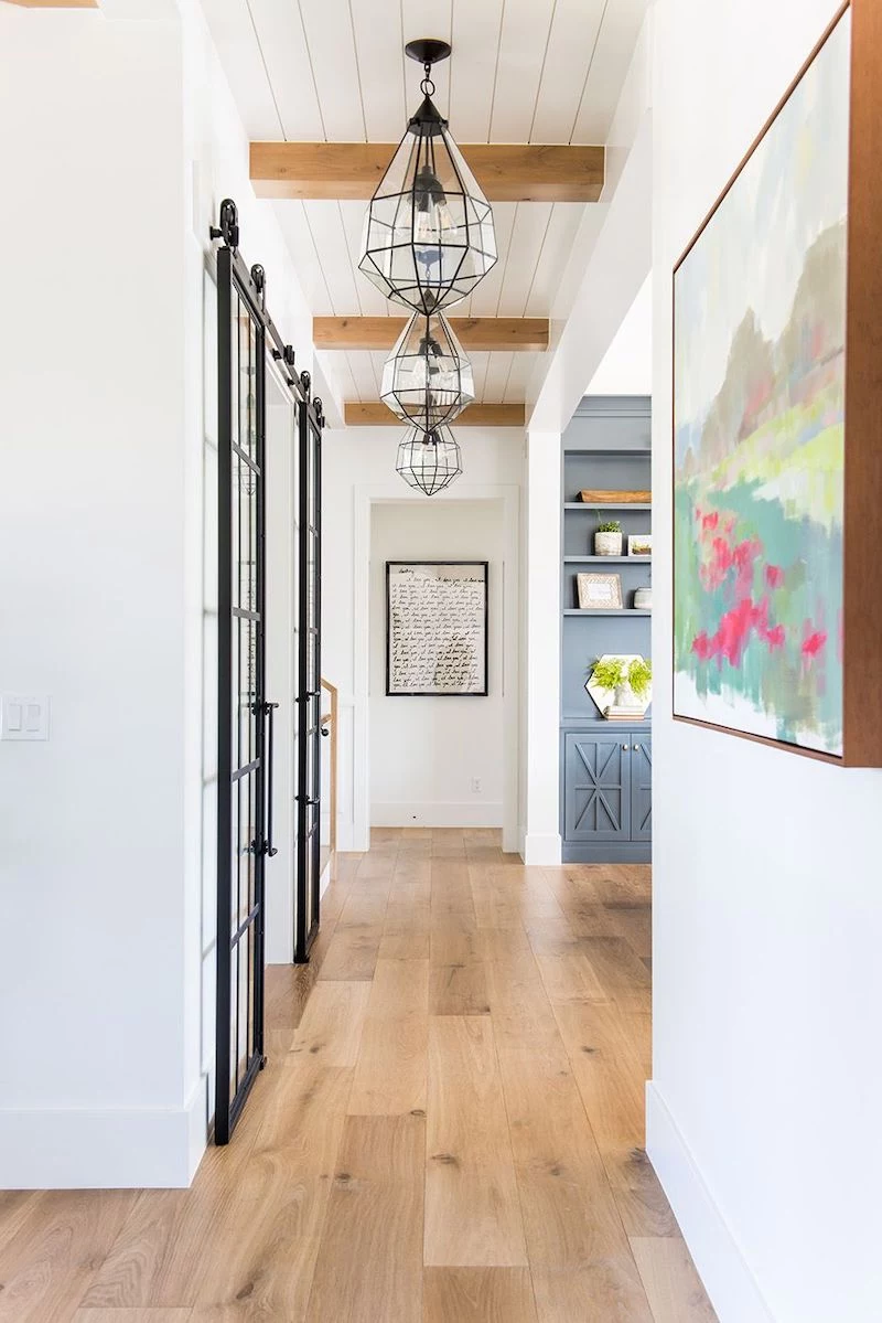 repeating pendant lighting down the hallway