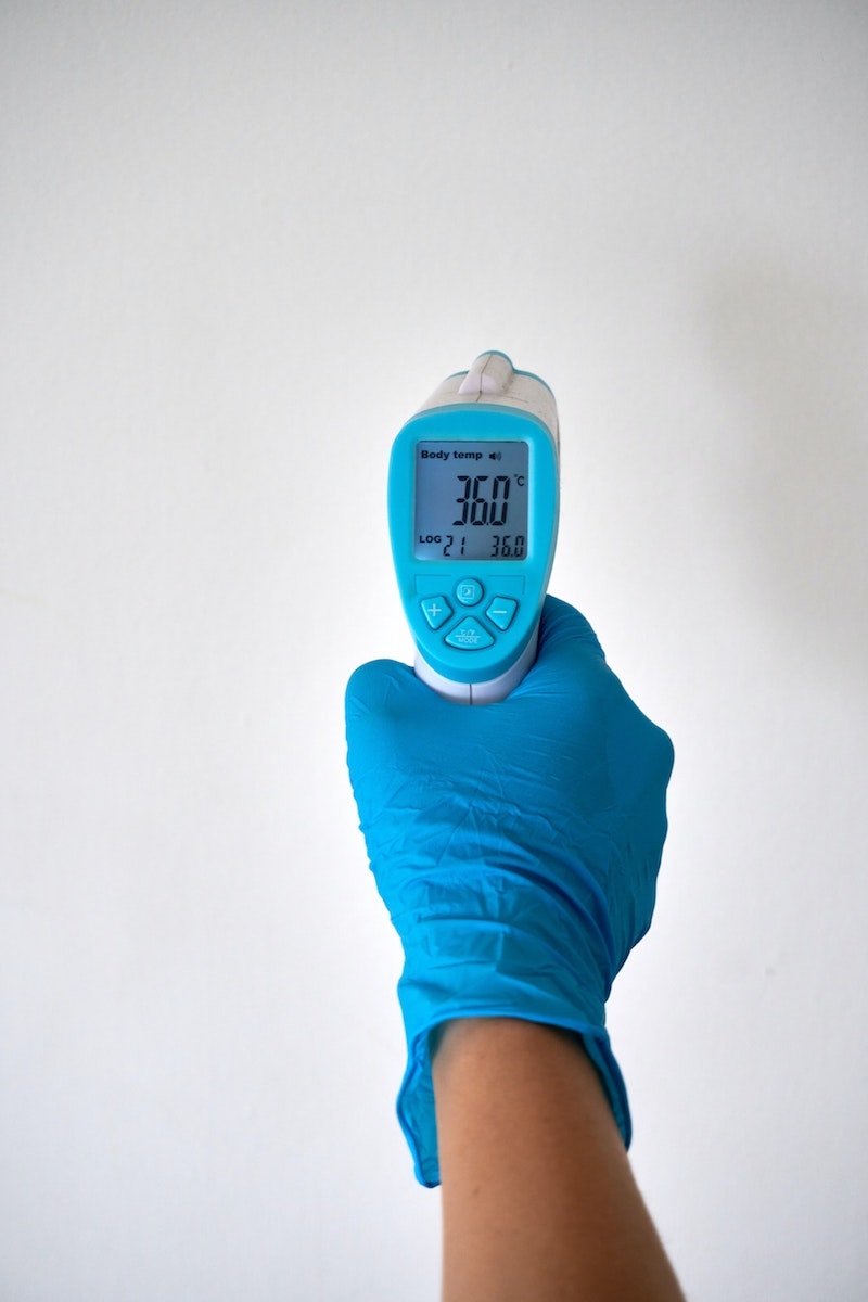 apple cider vinegar weight loss hand with blue glove holding thermometor