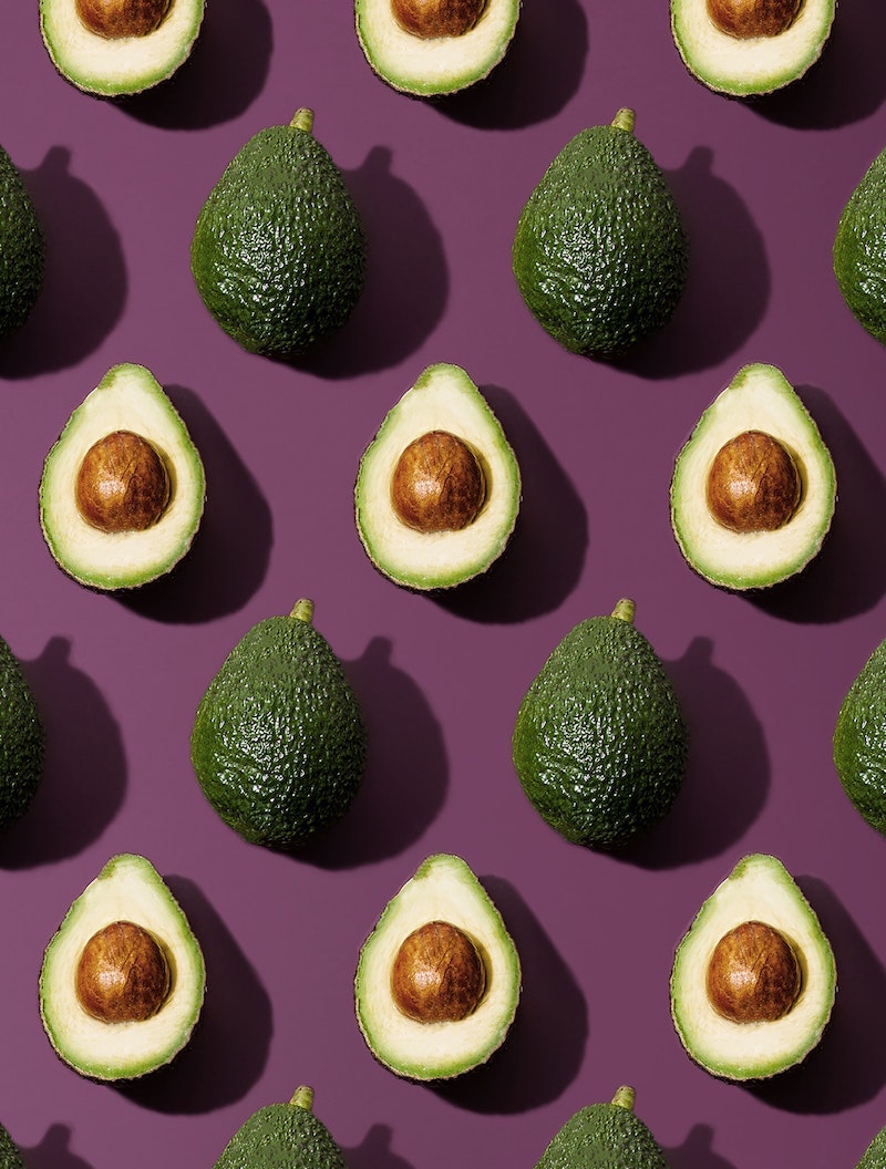 avocado sliced and whole pattern on purple background