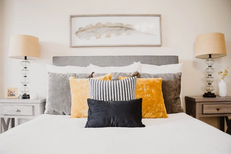 bed with colorful many pillows