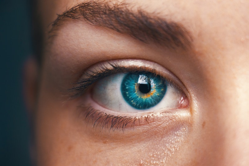 close up of womans eye blue green
