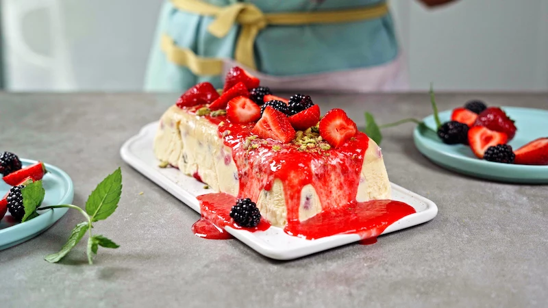 homemade semifreddo ice cream with decorations of berries and puree