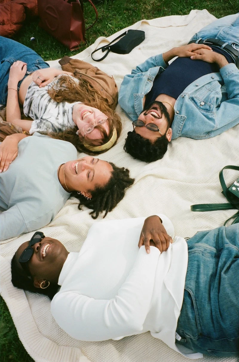 people laying on a white blanket