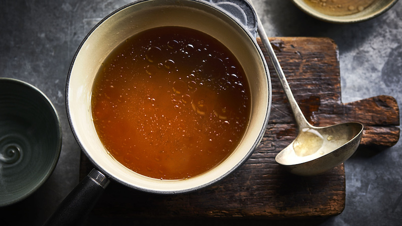 strong immune system bone broth in black pan
