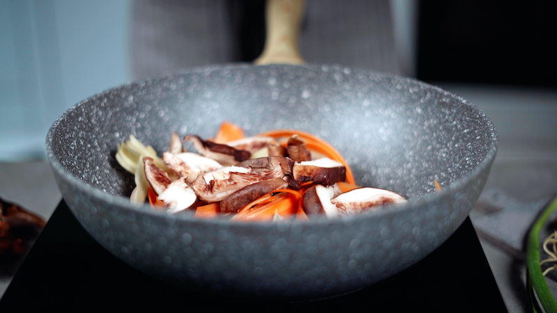 sweet and sour noodles carrots and mushrooms in wok