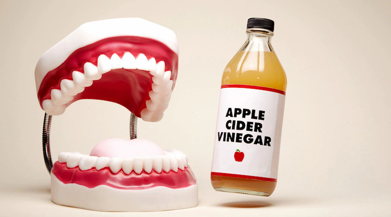 teeth and apple cider vinegar bottle